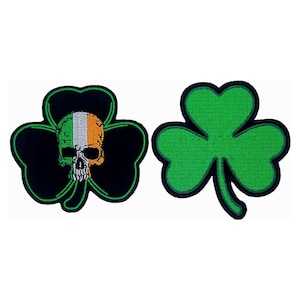 May include: Two embroidered shamrock patches. One shamrock is green and the other is black with a green outline and a white skull with an Irish flag design.