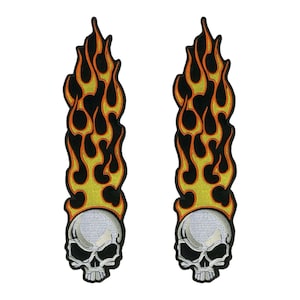 May include: Two black and orange embroidered patches of a skull with flames. The skull is white with black eyes and a black mouth. The flames are orange and yellow.