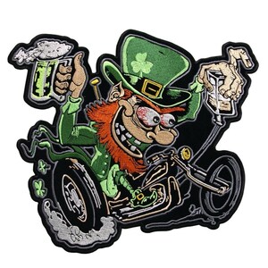 May include: Embroidered patch featuring a cartoon leprechaun riding a motorcycle. The leprechaun has red hair, a green hat with a shamrock, and is holding a beer mug and a shot. The patch has a black background and a white border.