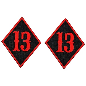 May include: Two black diamond-shaped patches with red embroidered number "13" in a stylized font.