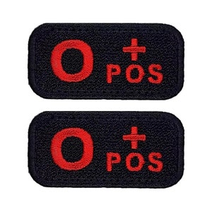 May include: Two black rectangular patches with red embroidered text. The text reads "O+ POS".