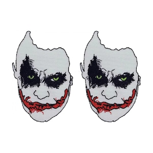 May include: Two white embroidered patches of the Joker's face with a red smile and green eyes.