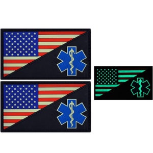 May include: Two black and white American flag patches with a blue star of life and a snake. The patches are glow-in-the-dark and have a green star of life and snake.