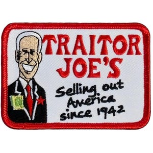 May include: A white embroidered patch with a red border. The patch features a cartoon image of a man with a red tie and a red star on his lapel. The text on the patch reads "Traitor Joe's Selling out America since 1942".
