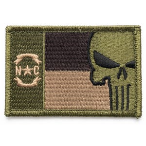 May include: Rectangular patch with a green border. The patch features a skull design on the right side, with a black and brown color scheme. The left side has a circular emblem with the letters "N" and "C" inside.