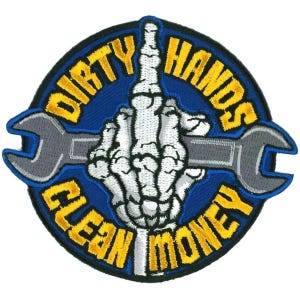 May include: A blue and yellow embroidered patch with a skeleton hand holding a wrench. The text on the patch reads "Dirty Hands Clean Money".