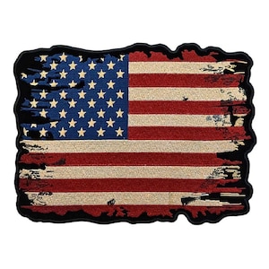 May include: A distressed American flag patch with a frayed edge. The flag is red, white, and blue with a black border.