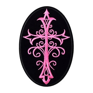 May include: Pink embroidered cross with ornate details on a black oval patch.