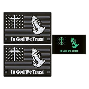 May include: Two black and gray patches with a white cross and praying hands, and the words "In God We Trust". The patches are glow-in-the-dark and have a black background with a green cross and praying hands.