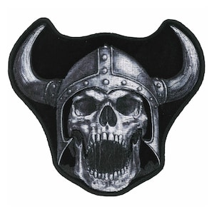 May include: Embroidered patch featuring a detailed skull wearing a Viking helmet with horns. The skull has an open mouth and is rendered in shades of gray and white, set against a black background.