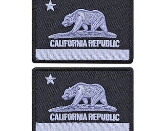 May include: Two black embroidered patches featuring a white star, a white bear, and the text "CALIFORNIA REPUBLIC" in white. The patches are rectangular and have a white border.