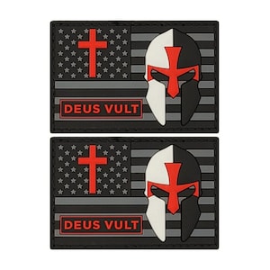 May include: Two black and gray embroidered patches with a red cross, a white and black knight helmet, and the text "DEUS VULT" in red.