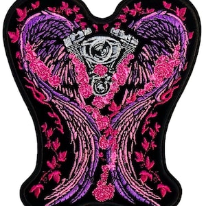 May include: Embroidered patch with a pink and purple heart-shaped design featuring angel wings and a stylized engine. The patch is on a black background.