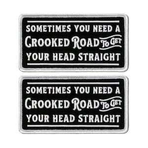 May include: Two black and white embroidered patches with white stitching. The patches are rectangular and have a white border. The text on the patches reads "Sometimes you need a crooked road to get your head straight."