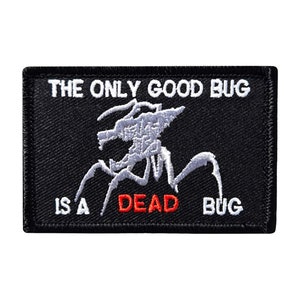 May include: Black embroidered patch with white stitching depicting a bug with the text "THE ONLY GOOD BUG IS A DEAD BUG" in white with the word "DEAD" in red.