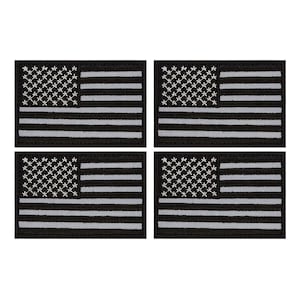 May include: Set of four black and white American flag patches. Each patch is approximately 2 inches by 3 inches.