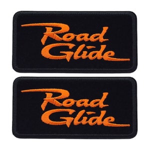 May include: Two black embroidered patches with the text "Road Glide" in orange.