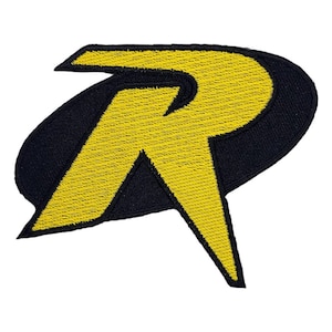 May include: Yellow and black embroidered patch with the letter "R" in a stylized font. The patch is shaped like an oval with a pointed bottom.