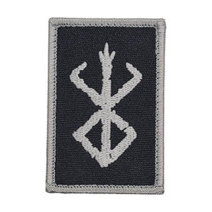 May include: A black embroidered patch with a white symbol, resembling a stylized 'X' with a pointed top and curved arms. The patch has a gray border.