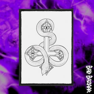 May include: A monochrome patch showing a snake entwined around a cross. The snake's scales are detailed, and the cross has decorative features. The patch has a black border, with the text "BAD BAZAR" visible in the image.