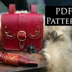 May include: A red leather bag with a buckle and decorative metal accents. The bag is on a wooden surface with a fur rug and a knife sheath. The image also includes a PDF pattern for the bag.