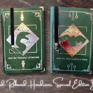 May include: Two green hardcover books with gold detailing and black bookmarks. The books are titled "Harry Potter and the Chamber of Secrets" and "Harry Potter and the Philosopher's Stone". The text "Hand Rebound Hardcover Special Edition Books" is also visible.