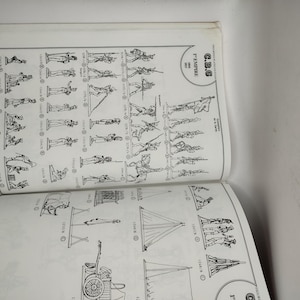 May include: A black and white illustrated guide to toy soldiers, featuring a variety of poses and formations. The guide includes a title page with the text "G.B.G. 1st Empire 1804-1815".
