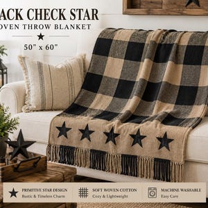 May include: A woven throw blanket featuring a black and tan buffalo check pattern with a row of five black stars along the bottom edge and fringe trim. The blanket measures 50 inches by 60 inches and is labeled as Black Check Star Woven Throw Blanket.