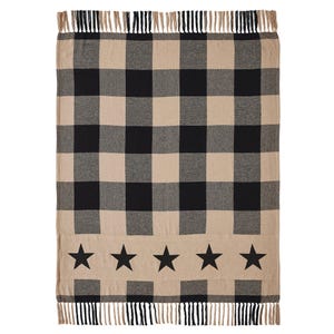 May include: A rectangular throw blanket featuring a black and beige buffalo check pattern. The lower section displays a horizontal band with five solid black stars. The top and bottom edges are finished with short, alternating black and beige fringe.