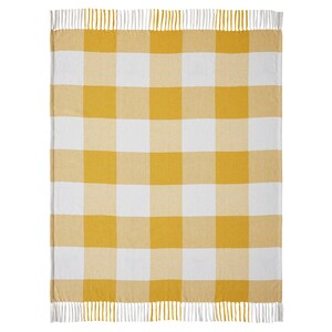 May include: A rectangular throw blanket featuring a large-scale yellow and white gingham check pattern. The blanket is finished with a fringe trim along the top and bottom edges, consisting of alternating yellow and white vertical yarn strands.