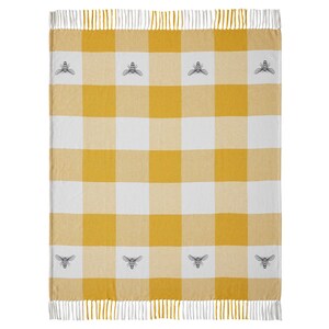 May include: A woven throw blanket featuring a yellow and white buffalo check pattern. The blanket is decorated with small, repeating grey bee illustrations centered within the white squares. It is finished with white fringe along the top and bottom.
