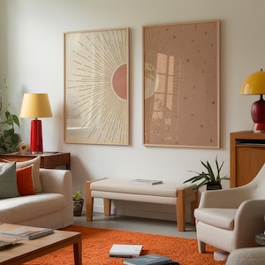 Living room interior featuring two large celestial sun and moon framed prints hanging above a beige bench.