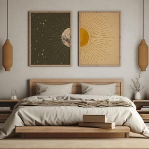 A minimalist bedroom featuring two framed sun and moon art prints centered above a wooden bed frame, flanked by matching nightstands with hanging woven pendant lights.