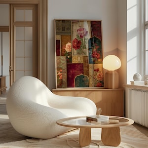 May include: A framed floral art print with a wooden frame. The artwork features a collage of floral patterns in shades of red, pink, and green. A white, rounded armchair and a wooden coffee table with a glass top are in the foreground.