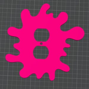 Puede incluir: Una tapa de toma de corriente de plástico rosa con forma de salpicadura de pintura.