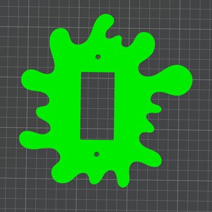 Puede incluir: Una placa de cubierta de interruptor de luz en forma de limo verde. La placa de cubierta tiene un recorte rectangular para un interruptor de luz estándar.