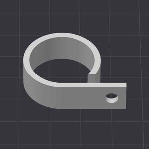 May include: A gray metal clamp with a circular section and a flat, rectangular extension. The extension features a single, circular hole. The clamp is designed to secure objects.