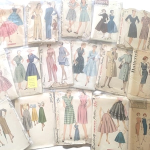 May include: A collection of vintage sewing patterns for dresses, skirts, and tops. The patterns are printed on paper and feature illustrations of the garments. The patterns are from the 1950s and are in good condition.