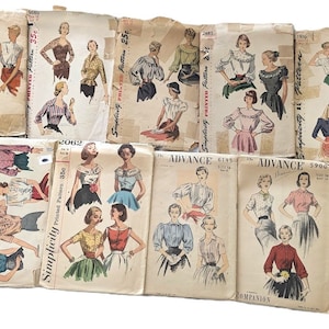 May include: A selection of vintage sewing patterns, depicting illustrations of women's blouses and skirts. The patterns are printed on aged paper, with visible text including the brands "Simplicity" and "Advance".