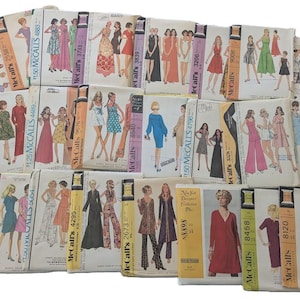 May include: A collection of vintage sewing patterns featuring various clothing designs for women. The patterns are from McCall's and include a variety of styles, such as dresses, skirts, pants, and tops. The patterns are printed on paper and have illustrations of the finished garments.