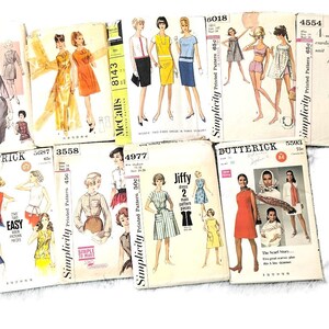 May include: A collection of vintage sewing patterns featuring illustrations of women's clothing designs. The patterns are from brands like Simplicity, Butterick, and McCall's, with prices and pattern numbers visible.
