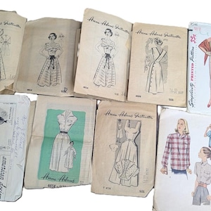 May include: A collection of vintage sewing patterns featuring various dress designs. The patterns are printed on paper and include instructions and diagrams for creating the garments. The patterns are from the Anne Adams and McCall brands.