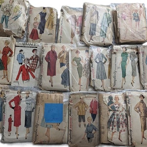 May include: A collection of vintage sewing patterns for clothing, featuring various designs and styles. The patterns are packaged in plastic bags and include Simplicity and Advance brands.