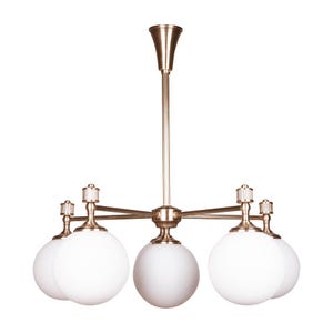 May include: A gold-toned chandelier with five white globe-shaped shades. The fixture has a central stem and radiating arms, each holding a light. The design is classic and elegant, suitable for various interior styles.