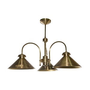 May include: A brass-coloured chandelier featuring three downward-facing conical shades. The central stem supports curved arms holding the shades. The fixture is designed for ceiling mounting and has a vintage aesthetic.
