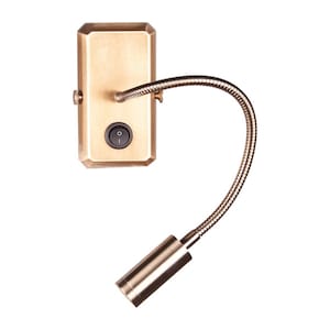 May include: A brass-coloured wall-mounted reading light with a flexible gooseneck arm. The light has a rectangular base with an on/off switch and a cylindrical lamp head. The design is simple and modern, suitable for bedside or task lighting.