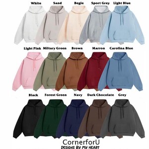 May include: A selection of hooded sweatshirts in a range of colours, such as white, sand, light blue, and black. Each sweatshirt has a front pocket and a drawstring hood. The image also displays the text "CornerforU DESIGNS BY MY HEART".