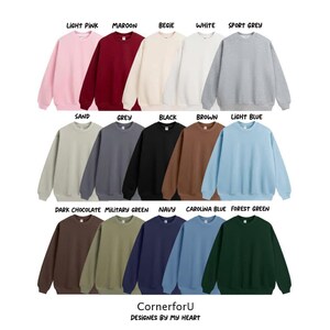 May include: A selection of crewneck sweatshirts in a range of colours: light pink, maroon, beige, white, sport grey, sand, grey, black, brown, light blue, dark chocolate, military green, navy, carolina blue, and forest green. The brand name "CornerforU" is visible.