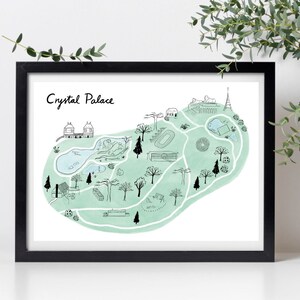 Puede incluir: Un dibujo en blanco y negro de Crystal Palace, un parque en Londres, Inglaterra. El dibujo está sobre un fondo blanco con una lavada de acuarela verde claro. El dibujo incluye un lago, árboles, edificios y una pista de atletismo.