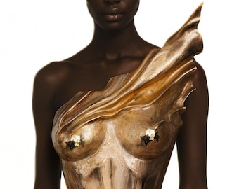 May include: A metallic gold-toned sculptural bodice featuring a fluid, draped texture that extends upward over one shoulder. The garment is form-fitting with a contoured shape and includes small, reflective star-shaped accents on the chest area.